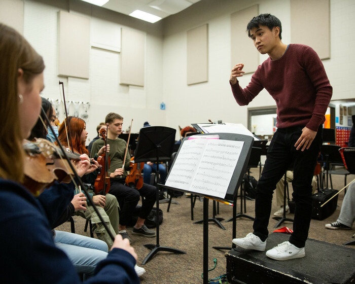 Zhu working with students at Des Moines Public Schools